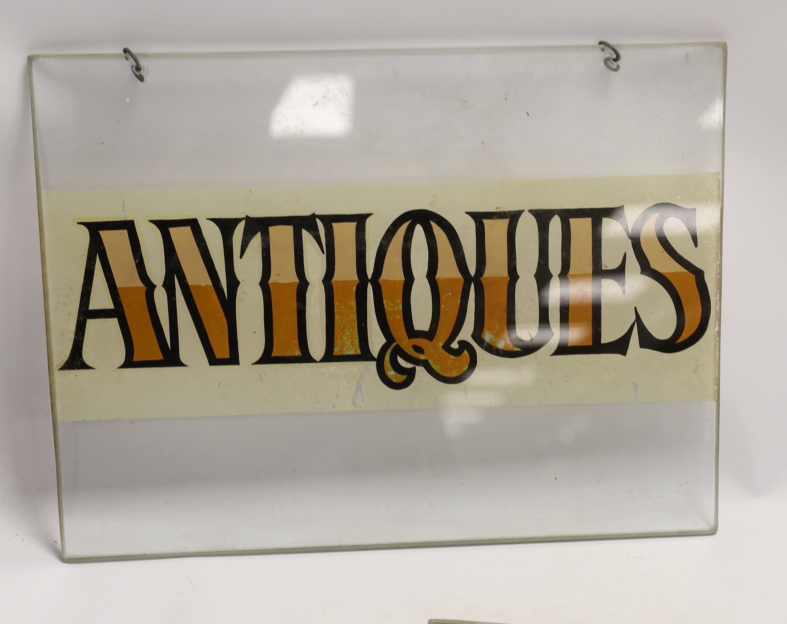 A pair of reverse painted glass 'antique' signs, 28 x 38cm